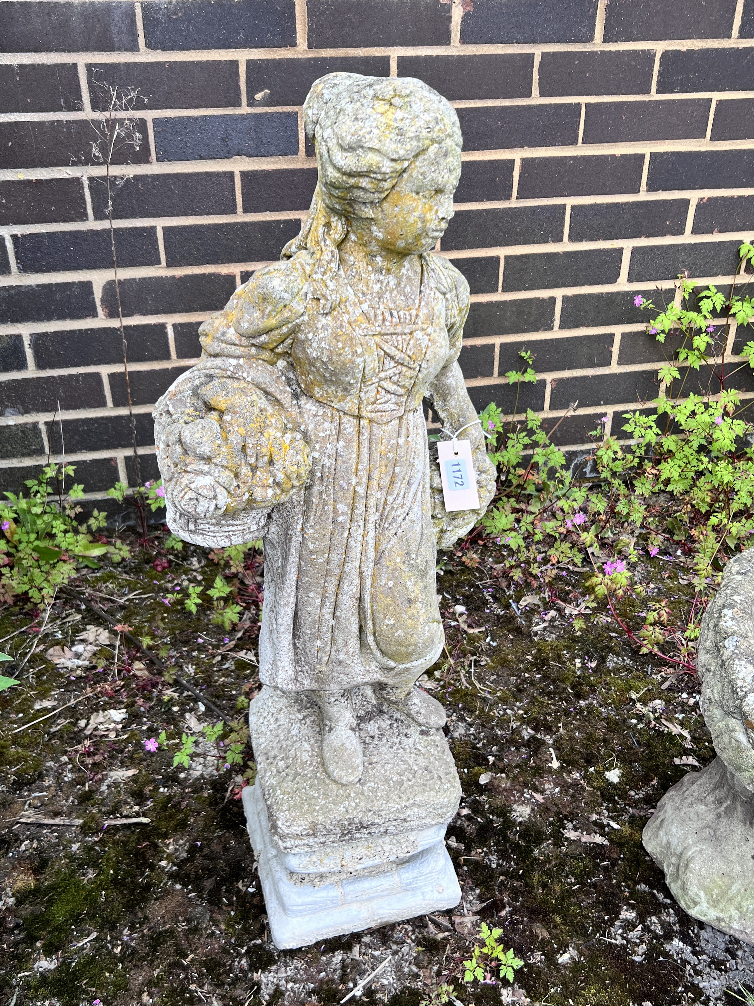 A reconstituted stone garden statue of a flower girl, height 90cm